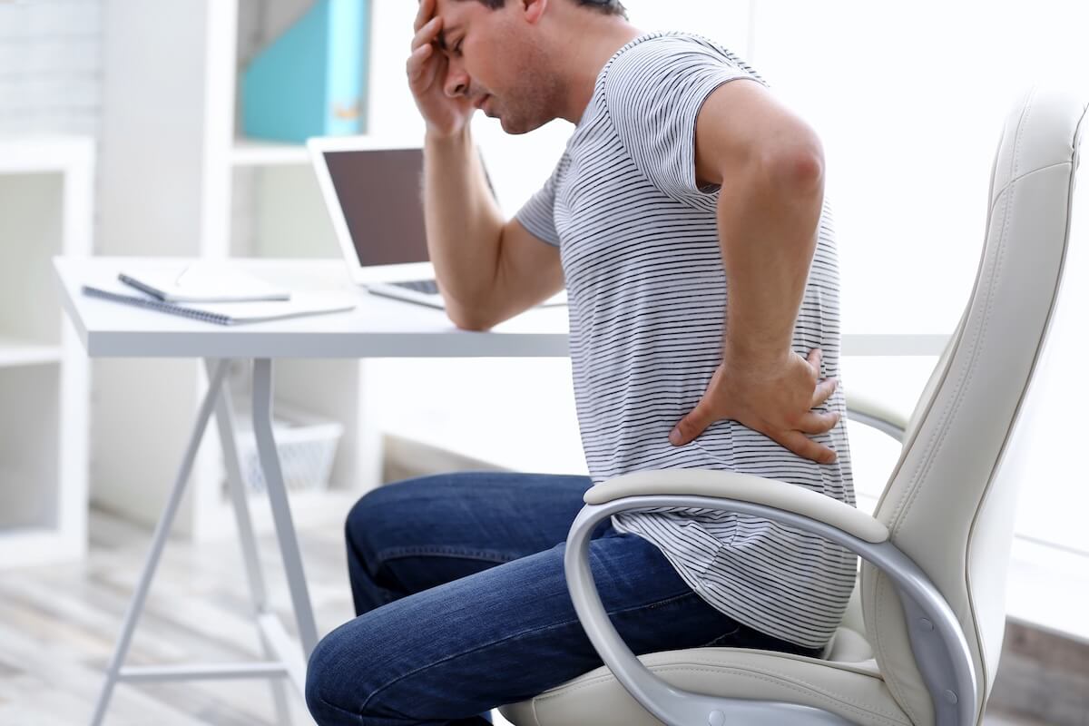 Man with back pain at desk